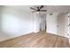 Spacious bedroom with modern ceiling fan and wood floors, leading to ensuite bathroom and closet at 5335 Rod Ct # 103, Las Vegas, NV 89122