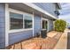 A beautiful condo exterior showcases light blue siding and private patio area with updated air conditioning at 5335 Rod Ct # 103, Las Vegas, NV 89122