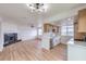 Open-concept living room and kitchen area with fireplace and updated flooring at 5335 Rod Ct # 103, Las Vegas, NV 89122