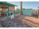 Spacious backyard featuring a covered patio, storage shed, gravel ground cover and mature landscaping at 553 Dutchman Ave, Henderson, NV 89011