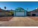 Exterior of the property featuring desert landscaping, a concrete driveway, and a large two-car garage at 553 Dutchman Ave, Henderson, NV 89011