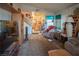 Spacious living room with plush carpeting, comfortable seating, and a staircase leading to the upper level at 553 Dutchman Ave, Henderson, NV 89011