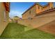 Well-maintained backyard with artificial turf and privacy wall at 5642 Breckenridge St, North Las Vegas, NV 89081