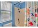 Bright bathroom featuring a shower with colorful fish-themed curtains and a window at 5642 Breckenridge St, North Las Vegas, NV 89081