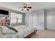 Charming bedroom featuring a cozy bed, modern fan and a large closet at 5642 Breckenridge St, North Las Vegas, NV 89081