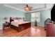 Comfortable bedroom featuring a ceiling fan, wood floors and a wooden bed frame at 5642 Breckenridge St, North Las Vegas, NV 89081
