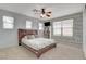 Cozy bedroom with a queen-sized bed, ceiling fan, and natural wood accent wall at 5642 Breckenridge St, North Las Vegas, NV 89081