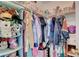 Walk-in closet with shelving units and lots of clothes at 5642 Breckenridge St, North Las Vegas, NV 89081