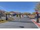 Gated community entrance with well-maintained landscaping, and visible neighborhood homes at 5642 Breckenridge St, North Las Vegas, NV 89081