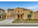 Two-story home with a tile roof, multi-car garage, well-manicured lawn, and drought-resistant landscaping at 5642 Breckenridge St, North Las Vegas, NV 89081