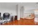 Hallway with wood floors, wood railing, and an office area with a desk at 5642 Breckenridge St, North Las Vegas, NV 89081