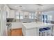 Bright kitchen features stainless steel appliances, a large center island, and modern white cabinetry at 5642 Breckenridge St, North Las Vegas, NV 89081