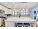 Bright kitchen boasts a center island, stainless steel appliances, and contemporary finishes at 5642 Breckenridge St, North Las Vegas, NV 89081
