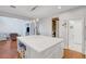 Bright kitchen island with white countertop and barstool seating is ideal for casual dining at 5642 Breckenridge St, North Las Vegas, NV 89081