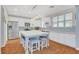 Bright kitchen with white cabinets, a large island with seating, stainless steel appliances and modern lighting at 5642 Breckenridge St, North Las Vegas, NV 89081