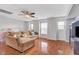 Spacious living room with wood floors, ceiling fan, and plenty of natural light at 5642 Breckenridge St, North Las Vegas, NV 89081