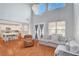 Bright living room with a soaring ceiling, hardwood floors, and natural light throughout at 5642 Breckenridge St, North Las Vegas, NV 89081
