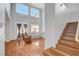 Bright living room with high ceilings, wood floors, comfortable seating, and large windows for natural light at 5642 Breckenridge St, North Las Vegas, NV 89081