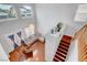 Open-concept living space with high ceilings, large windows, hardwood floors, and modern furniture at 5642 Breckenridge St, North Las Vegas, NV 89081