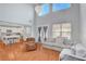 Bright living area features hardwood floors, a modern chandelier, and an open flow to the kitchen at 5642 Breckenridge St, North Las Vegas, NV 89081