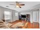 Spacious living room with a ceiling fan and a TV at 5642 Breckenridge St, North Las Vegas, NV 89081