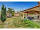 Inviting covered patio with comfortable seating and lush landscaping at 5642 Breckenridge St, North Las Vegas, NV 89081