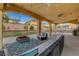 Relaxing patio area featuring stylish outdoor furniture and a ceiling fan at 5642 Breckenridge St, North Las Vegas, NV 89081