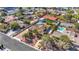 A high angle shot of a single-Gathering home with a pool in a suburban neighborhood at 6117 Foxcroft Ave, Las Vegas, NV 89108