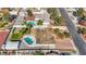 Elevated perspective revealing the house's location within a neighborhood with swimming pools and mature landscaping at 6117 Foxcroft Ave, Las Vegas, NV 89108