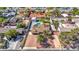 An aerial view of a ranch-style home with a private pool, mature trees and desert landscaping in a quiet neighborhood at 6117 Foxcroft Ave, Las Vegas, NV 89108