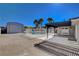 Spacious backyard featuring a gated pool area, covered patio, and large detached garage, perfect for outdoor living at 6117 Foxcroft Ave, Las Vegas, NV 89108