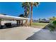 Backyard featuring covered patio with bar, mature landscaping, and a spacious lawn for outdoor activities at 6117 Foxcroft Ave, Las Vegas, NV 89108