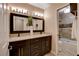 Bathroom with dual sinks, granite countertops, and a shower and tub combination at 6117 Foxcroft Ave, Las Vegas, NV 89108