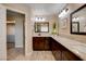 Modern bathroom with double vanity sinks, granite countertop, and a separate door to the water closet at 6117 Foxcroft Ave, Las Vegas, NV 89108