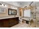 Luxurious bathroom featuring a soaking tub and glass-enclosed shower at 6117 Foxcroft Ave, Las Vegas, NV 89108