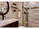 Bathroom featuring granite countertop, sleek fixtures and beautifully tiled shower at 6117 Foxcroft Ave, Las Vegas, NV 89108