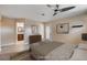 Well-lit bedroom featuring a ceiling fan and an exterior door at 6117 Foxcroft Ave, Las Vegas, NV 89108
