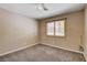 Bedroom features modern lighting, neutral colors and a window with plantation shutters at 6117 Foxcroft Ave, Las Vegas, NV 89108