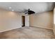 Large bedroom featuring neutral walls, plush carpeting, ceiling fan and access to a walk-in closet at 6117 Foxcroft Ave, Las Vegas, NV 89108