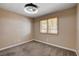 Bedroom features modern lighting, neutral colors and a window with plantation shutters at 6117 Foxcroft Ave, Las Vegas, NV 89108