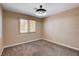 Neutral bedroom with carpet, modern ceiling fan, and light-filtering shutters at 6117 Foxcroft Ave, Las Vegas, NV 89108