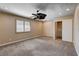 Bedroom featuring a ceiling fan, window with shutters, neutral carpet, and closet with sliding doors at 6117 Foxcroft Ave, Las Vegas, NV 89108