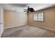 Spacious bedroom with neutral carpet, ceiling fan, and window with shutters at 6117 Foxcroft Ave, Las Vegas, NV 89108