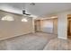 Large bonus room with carpet, ceiling fan, arched windows and built-in storage at 6117 Foxcroft Ave, Las Vegas, NV 89108