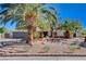 Charming single-story home featuring drought-resistant landscaping with mature palm trees and a two-car garage at 6117 Foxcroft Ave, Las Vegas, NV 89108