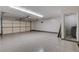 Spacious garage featuring durable flooring, an overhead garage door, and ample room for vehicles and storage at 6117 Foxcroft Ave, Las Vegas, NV 89108