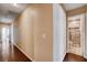 Hallway featuring hard wood floors leading to tiled bathroom with shower at 6117 Foxcroft Ave, Las Vegas, NV 89108