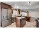 Spacious kitchen boasts stainless steel appliances, two islands, and dark wood cabinets at 6117 Foxcroft Ave, Las Vegas, NV 89108