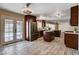 Bright kitchen featuring a center island, stainless steel refrigerator, and access to the backyard pool at 6117 Foxcroft Ave, Las Vegas, NV 89108