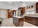 Kitchen area featuring an island, granite countertops, stainless steel appliances, and tile flooring at 6117 Foxcroft Ave, Las Vegas, NV 89108